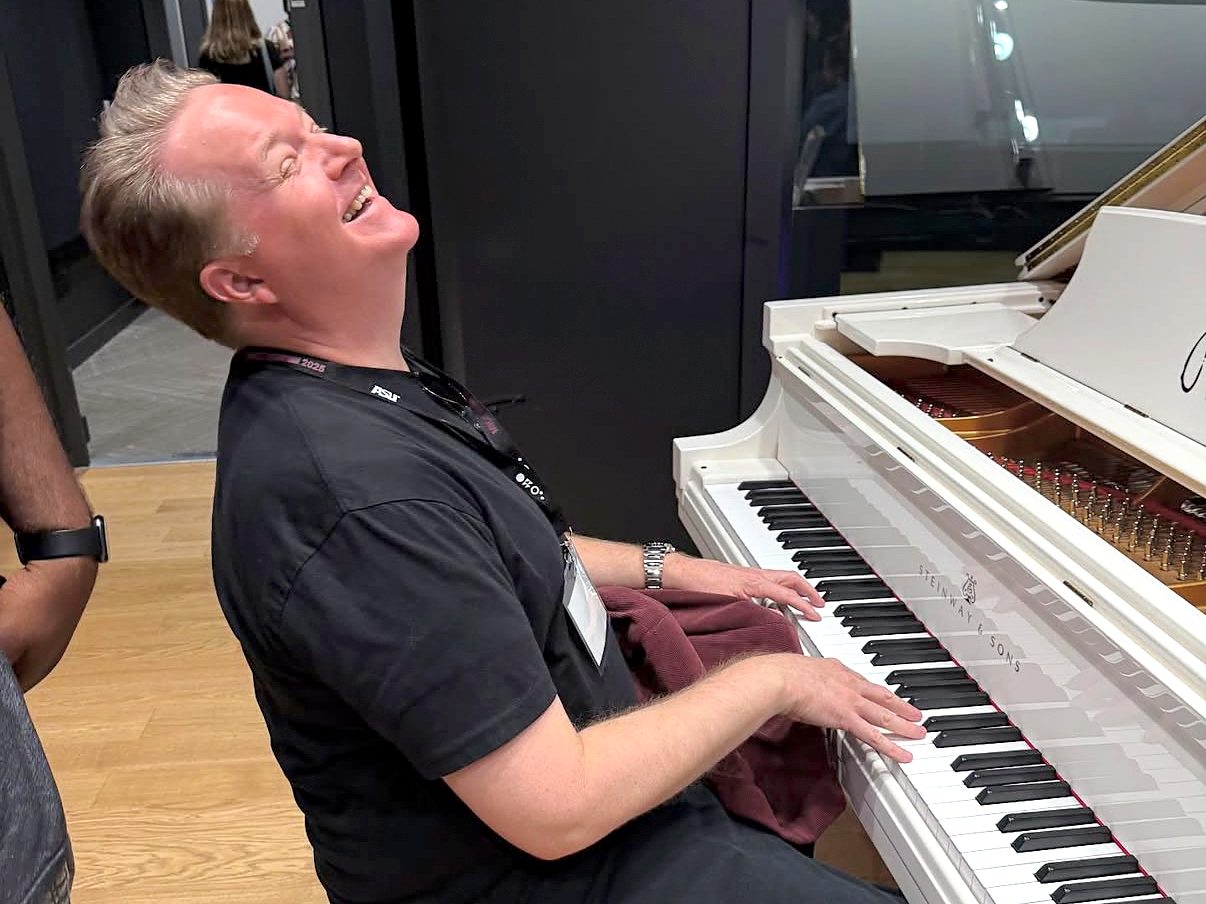 An attendee laughing at the piano